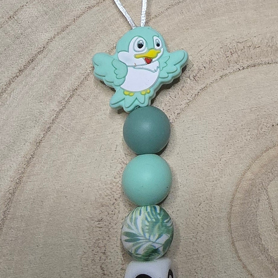 Attache-tétine personnalisée Modèle Ezio Oiseau et son feuillage tropical