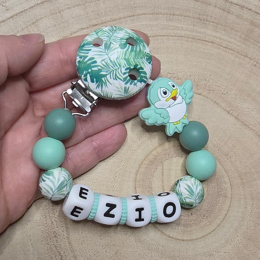 Attache-tétine personnalisée Modèle Ezio Oiseau et son feuillage tropical